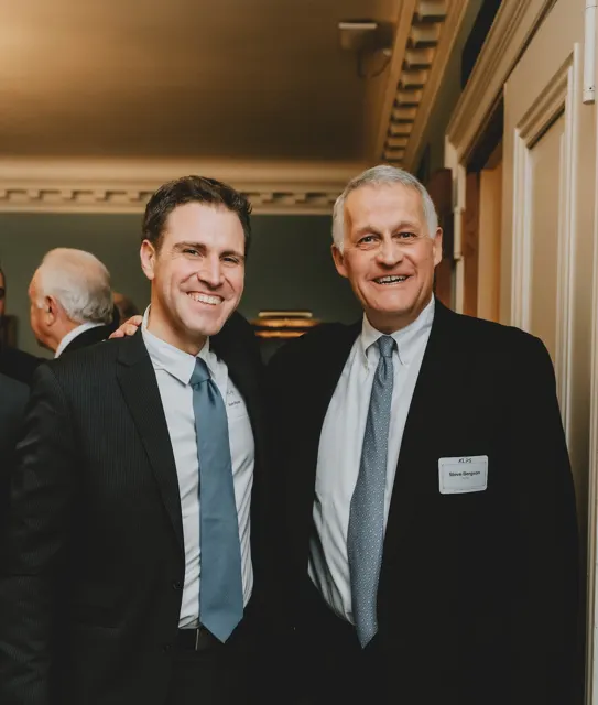 Sam with ALPS advisor Steve Bergson, both smiling, at an evening ALPS event