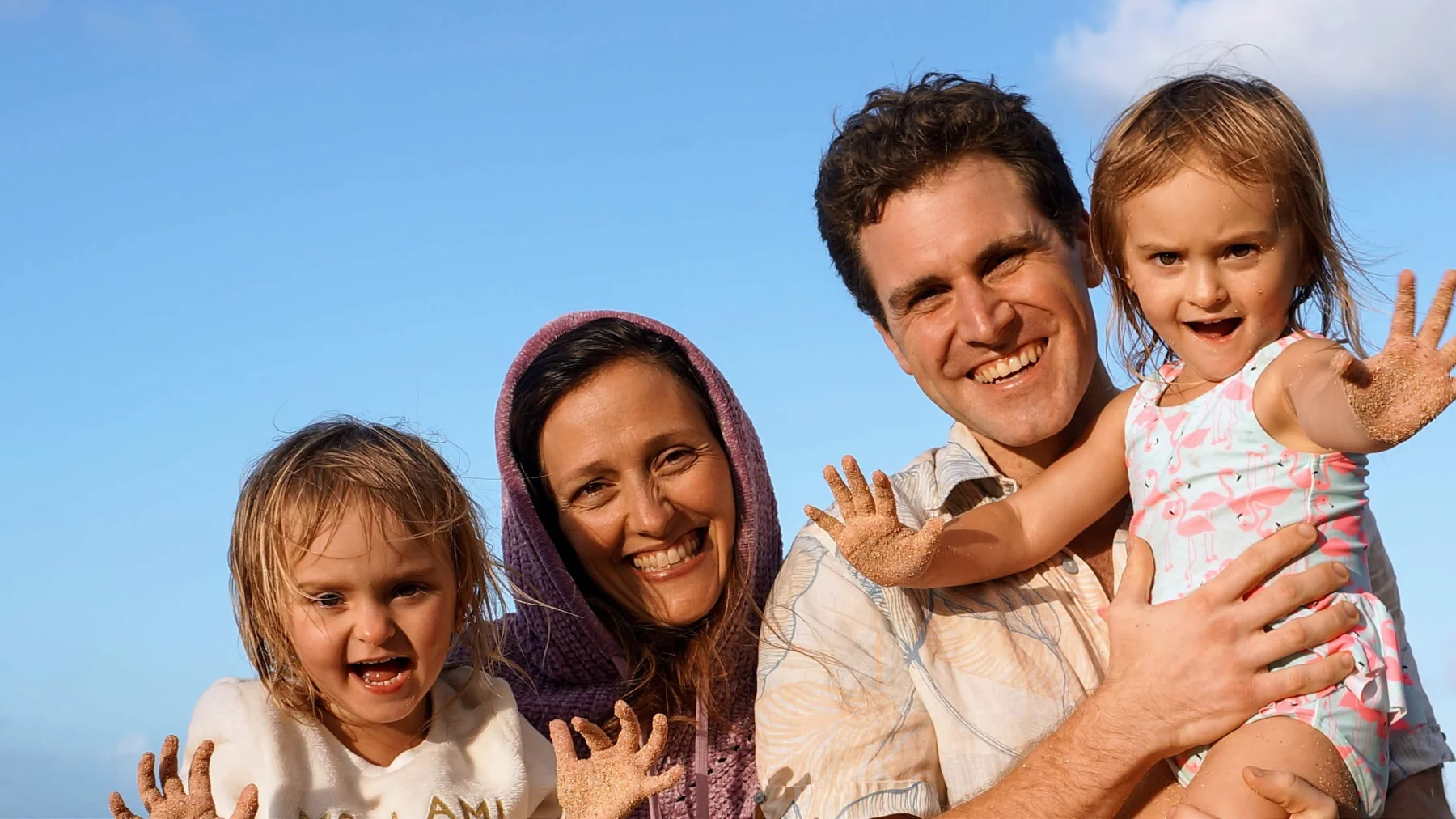The family on the beach, the girls riding on our shoulders and waving