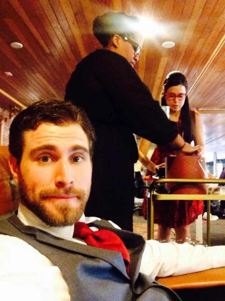 A selfie in the captain’s hat on the train, fellow passengers behind